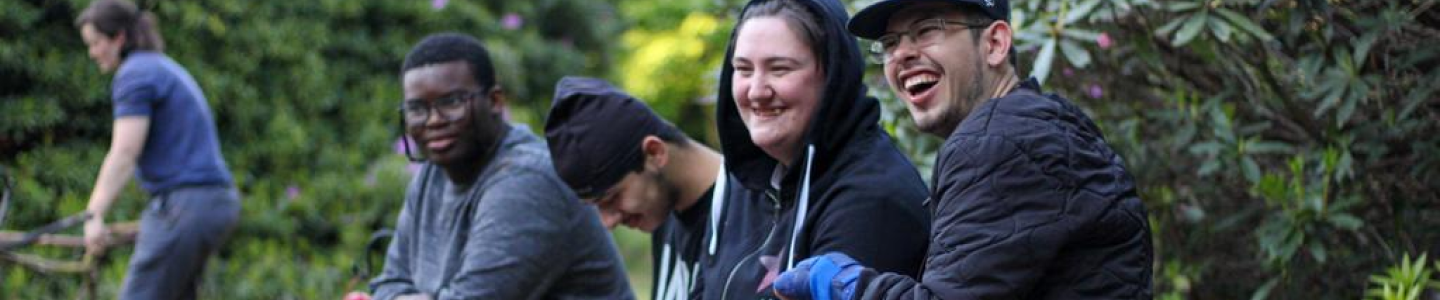 4 young people laughing in an outdoor setting.