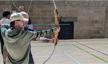 A person doing archery.