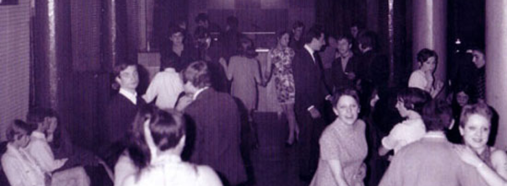 A vintage photograph of people dancing in a room.