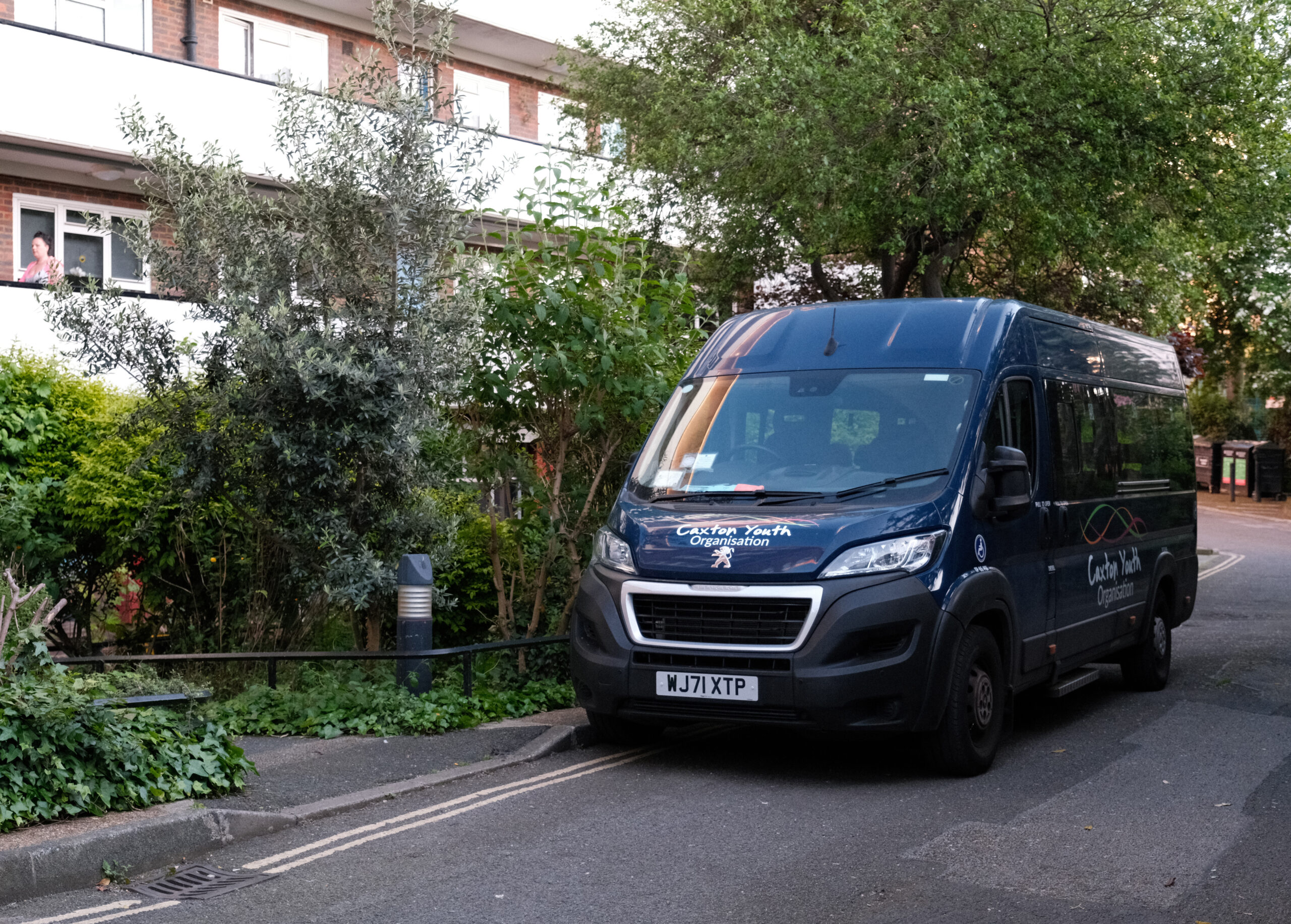 A parked dark blue minibus.