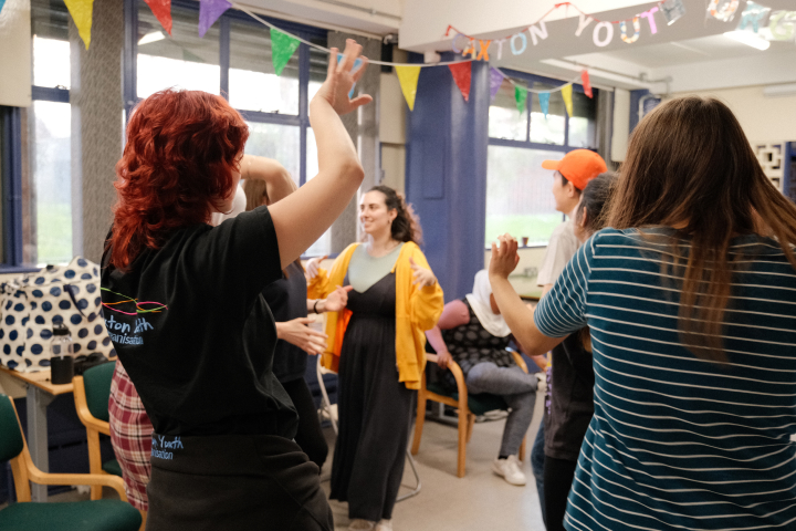 A group of people dancing in a room.