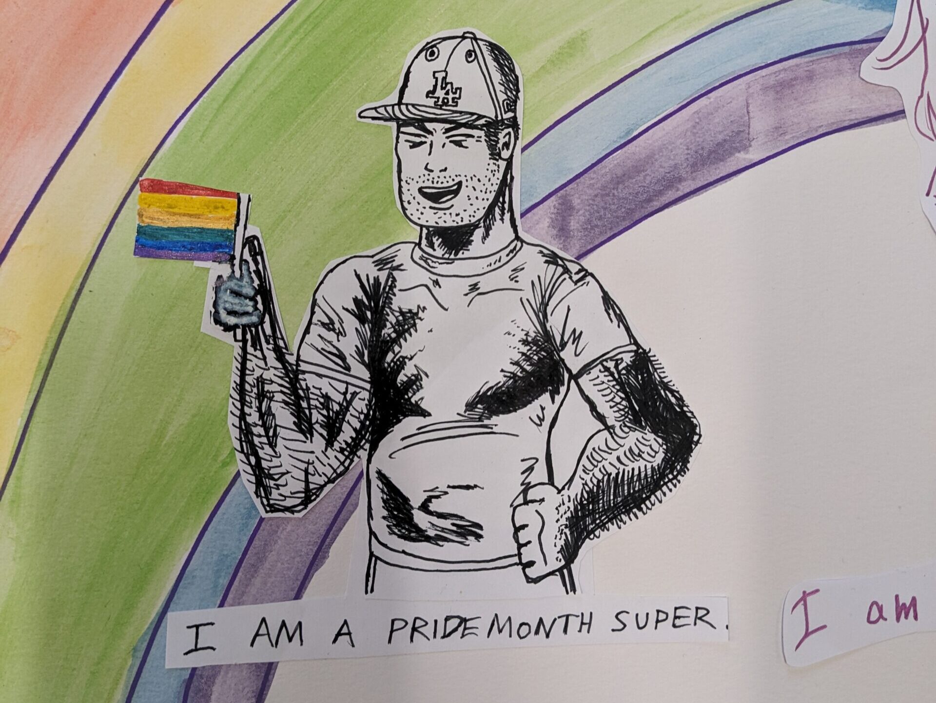 A hand-drawn picture of a boy holding a rainbow flag. Hand-written text under the character says: "I am Pride Month Super". There is a rainbow painted behind the character.